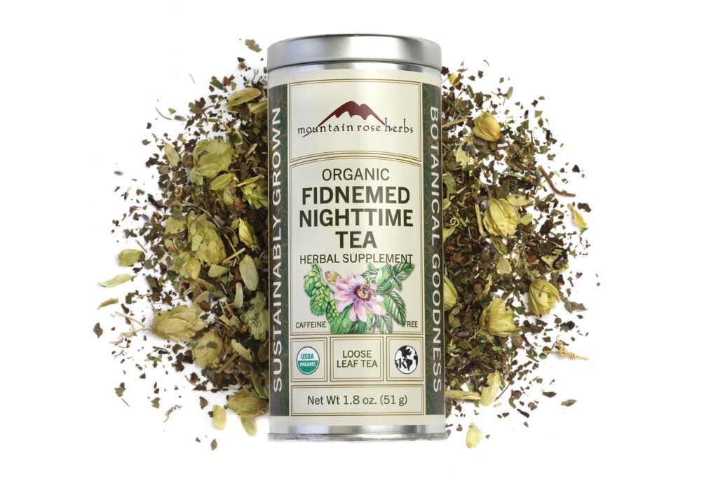 Organic Fidnemed Nighttime Tea can surrounded by loose herbal leaves and flowers. USDA Organic, caffeine-free.