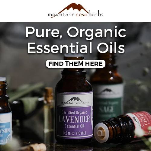 essentialoils Pure organic essential oils from Mountain Rose Herbs, featuring lavender and sage bottles on a dimly lit table.
